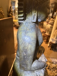 An Indian polished black marble sculpture of a Jina seated in dhyanasana on an ornate cushion, probably Gujarat, 15th C.