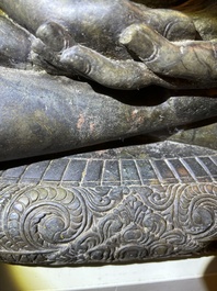 An Indian polished black marble sculpture of a Jina seated in dhyanasana on an ornate cushion, probably Gujarat, 15th C.