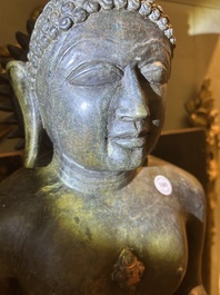 An Indian polished black marble sculpture of a Jina seated in dhyanasana on an ornate cushion, probably Gujarat, 15th C.