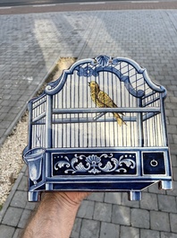 A polychrome Delftware birdcage plaque, Tichelaar, Makkum, Friesland, 19th C.