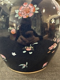A pair of Chinese blue ground jars with enamelled decoration of butterflies and flowers, 19th C.