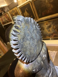 An Indian polished black marble sculpture of a Jina seated in dhyanasana on an ornate cushion, probably Gujarat, 15th C.