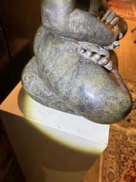 An Indian polished black marble sculpture of a Jina seated in dhyanasana on an ornate cushion, probably Gujarat, 15th C.