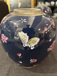 A pair of Chinese blue ground jars with enamelled decoration of butterflies and flowers, 19th C.
