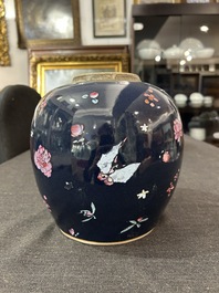 A pair of Chinese blue ground jars with enamelled decoration of butterflies and flowers, 19th C.