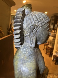 An Indian polished black marble sculpture of a Jina seated in dhyanasana on an ornate cushion, probably Gujarat, 15th C.