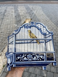 A polychrome Delftware birdcage plaque, Tichelaar, Makkum, Friesland, 19th C.