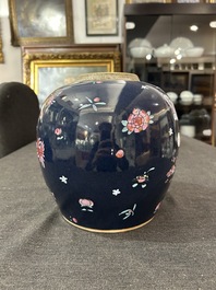 A pair of Chinese blue ground jars with enamelled decoration of butterflies and flowers, 19th C.