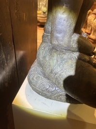 An Indian polished black marble sculpture of a Jina seated in dhyanasana on an ornate cushion, probably Gujarat, 15th C.