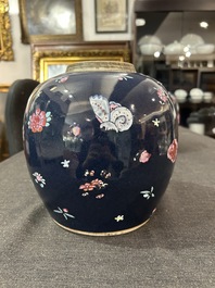 A pair of Chinese blue ground jars with enamelled decoration of butterflies and flowers, 19th C.