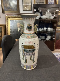 A Chinese famille rose 'antiquities' vase and a vase with figures in a garden, 19th/20th C.