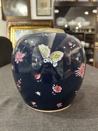 A pair of Chinese blue ground jars with enamelled decoration of butterflies and flowers, 19th C.