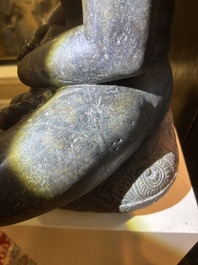 An Indian polished black marble sculpture of a Jina seated in dhyanasana on an ornate cushion, probably Gujarat, 15th C.