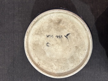 A pair of Chinese blue ground jars with enamelled decoration of butterflies and flowers, 19th C.