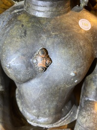 An Indian polished black marble sculpture of a Jina seated in dhyanasana on an ornate cushion, probably Gujarat, 15th C.