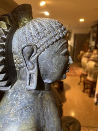 An Indian polished black marble sculpture of a Jina seated in dhyanasana on an ornate cushion, probably Gujarat, 15th C.