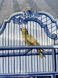 A polychrome Delftware birdcage plaque, Tichelaar, Makkum, Friesland, 19th C.