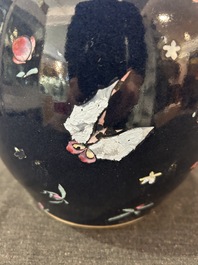 A pair of Chinese blue ground jars with enamelled decoration of butterflies and flowers, 19th C.