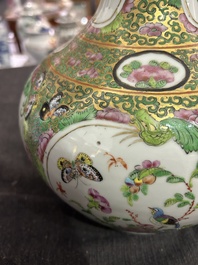 A Chinese bottle-shaped Canton famille rose vase with palace scenes and birds and butterflies among blossoming branches, 19th C.