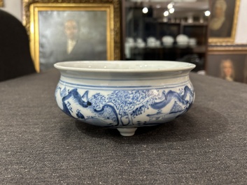 A Chinese blue and white tripod censer with figures in a landscape, 19th C.
