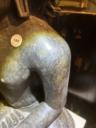 An Indian polished black marble sculpture of a Jina seated in dhyanasana on an ornate cushion, probably Gujarat, 15th C.