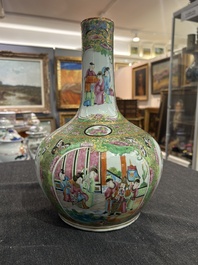 A Chinese bottle-shaped Canton famille rose vase with palace scenes and birds and butterflies among blossoming branches, 19th C.