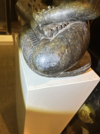 An Indian polished black marble sculpture of a Jina seated in dhyanasana on an ornate cushion, probably Gujarat, 15th C.