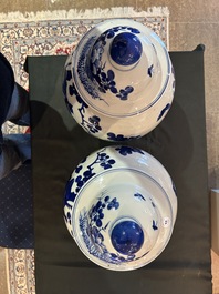 A pair of Chinese blue and white vases and covers with magpies among peonies, 19th C.