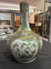 A Chinese bottle-shaped Canton famille rose vase with palace scenes and birds and butterflies among blossoming branches, 19th C.