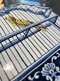 A polychrome Delftware birdcage plaque, Tichelaar, Makkum, Friesland, 19th C.