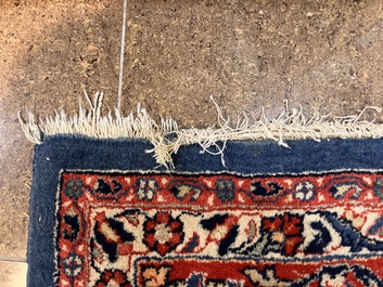 A Persian Sarouk rug with central medallion and floral design, wool on cotton, 20th C.