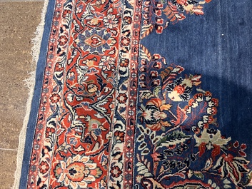 A Persian Sarouk rug with central medallion and floral design, wool on cotton, 20th C.