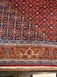 A Persian Bidjar rug with floral design, wool on cotton, 20th C.