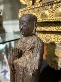 A Chinese cast iron sculpture of a Luohan, probably Ming