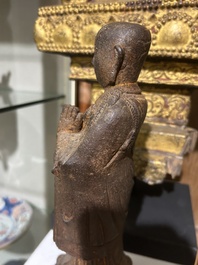 A Chinese cast iron sculpture of a Luohan, probably Ming