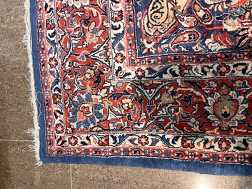 A Persian Sarouk rug with central medallion and floral design, wool on cotton, 20th C.