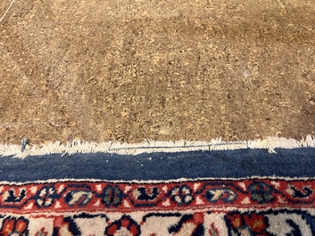 A Persian Sarouk rug with central medallion and floral design, wool on cotton, 20th C.