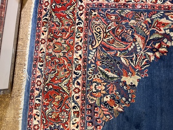 A Persian Sarouk rug with central medallion and floral design, wool on cotton, 20th C.