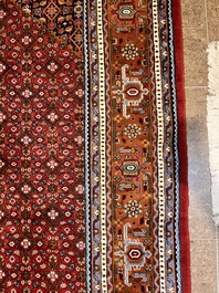 A Persian Bidjar rug with floral design, wool on cotton, 20th C.