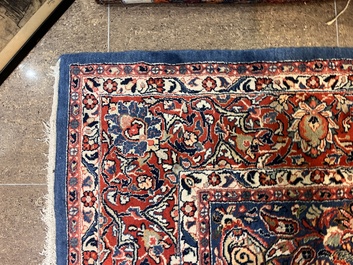 A Persian Sarouk rug with central medallion and floral design, wool on cotton, 20th C.