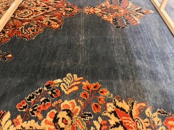 A Persian Sarouk rug with central medallion and floral design, wool on cotton, 20th C.