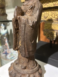 A Chinese cast iron sculpture of a Luohan, probably Ming