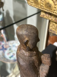 A Chinese cast iron sculpture of a Luohan, probably Ming