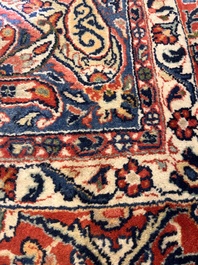 A Persian Sarouk rug with central medallion and floral design, wool on cotton, 20th C.