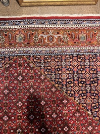 A Persian Bidjar rug with floral design, wool on cotton, 20th C.