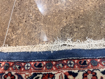 A Persian Sarouk rug with central medallion and floral design, wool on cotton, 20th C.