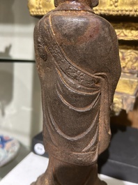 A Chinese cast iron sculpture of a Luohan, probably Ming