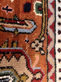 A Persian Bidjar rug with floral design, wool on cotton, 20th C.