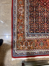 A Persian Bidjar rug with floral design, wool on cotton, 20th C.