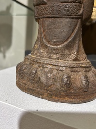 A Chinese cast iron sculpture of a Luohan, probably Ming